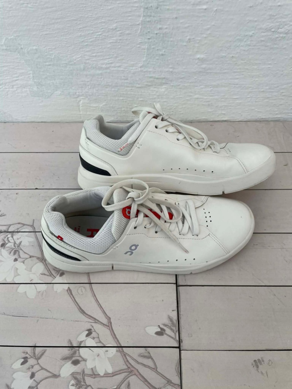 On Running White Sneakers with Black Heel Stripe and Red Details